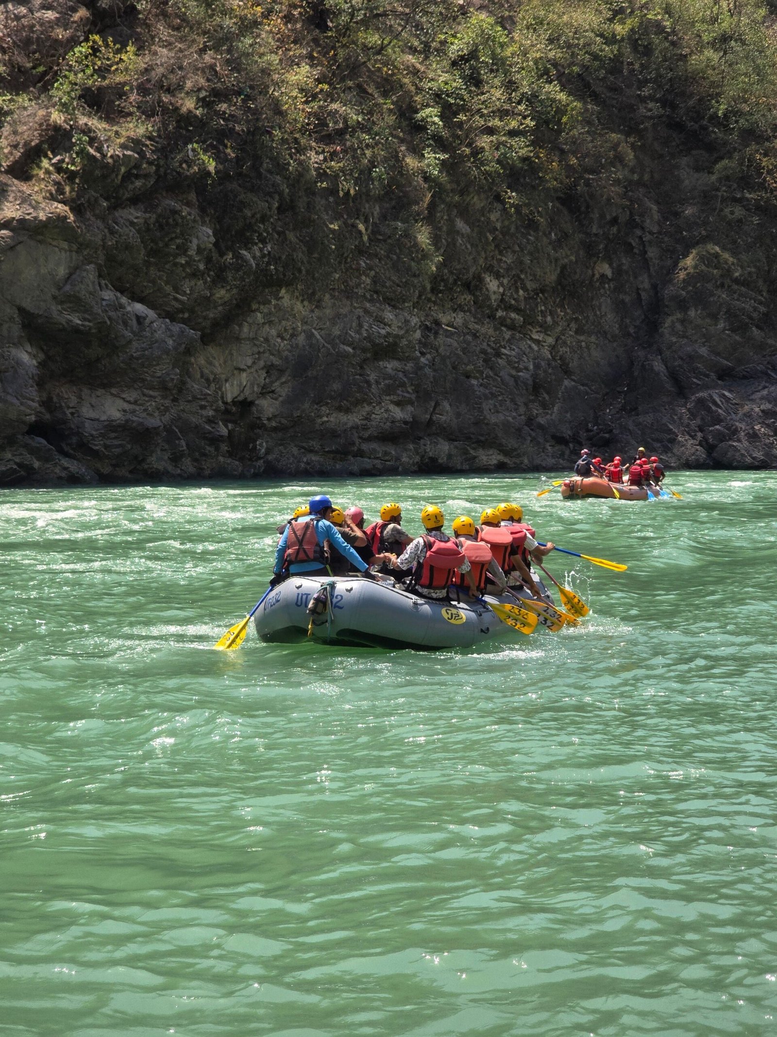 Group enjoying a thrilling whitewater rafting experience on the Ganges River in Rishikesh, India.